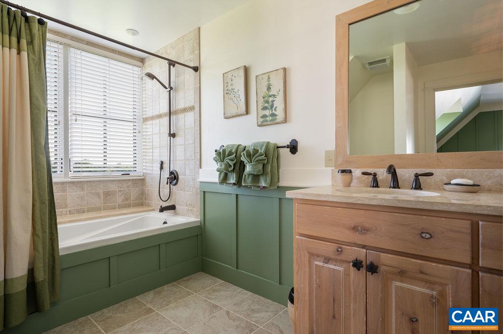 5095 Wesley Chapel Road Free Union, VA 22940 - Photo 37 of 75 a bathroom with a sink mirror and a bathtub