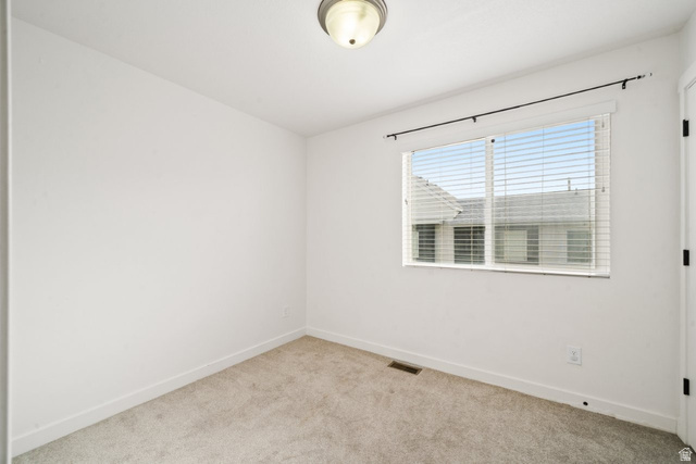 70 East Weekes Way Clearfield, UT 84015 - Photo 10 of 25 Spare room featuring baseboards and light colored carpet