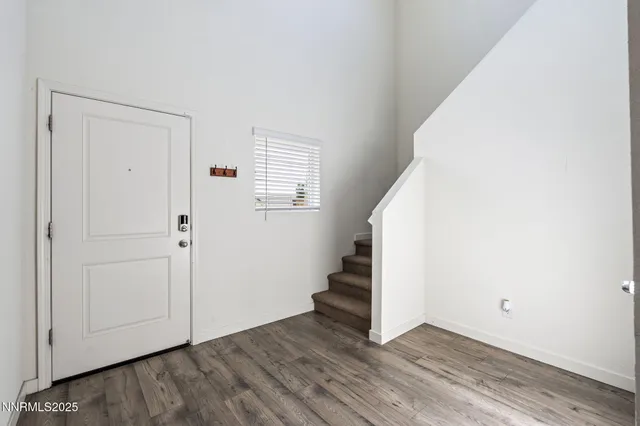 a view of an entryway with wooden floor