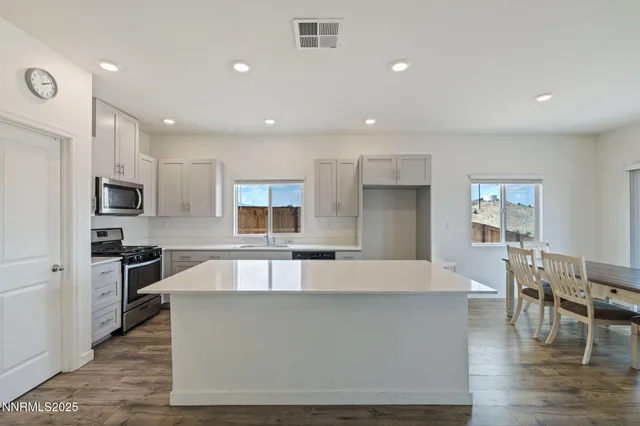 a large kitchen with stainless steel appliances