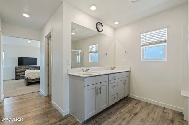 a spacious bathroom with a double vanity sink and a mirror