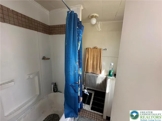 a view of a room with wooden floor and windows