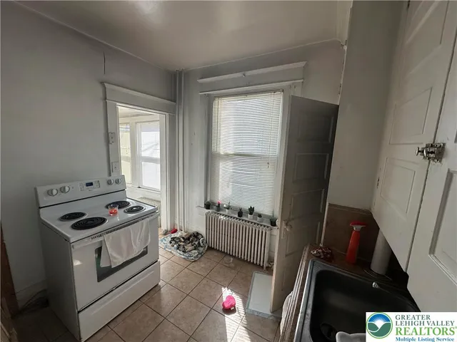 a kitchen with blue cabinets appliances and a window