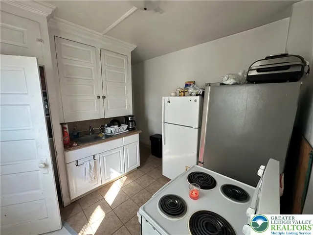 a kitchen with a refrigerator and white stove
