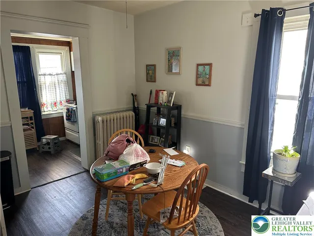 a view of a dining room with furniture window and wooden floor