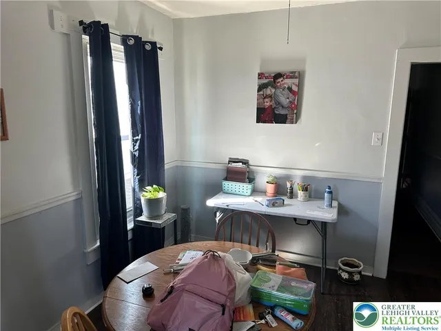 a view of a workspace with furniture and a gate