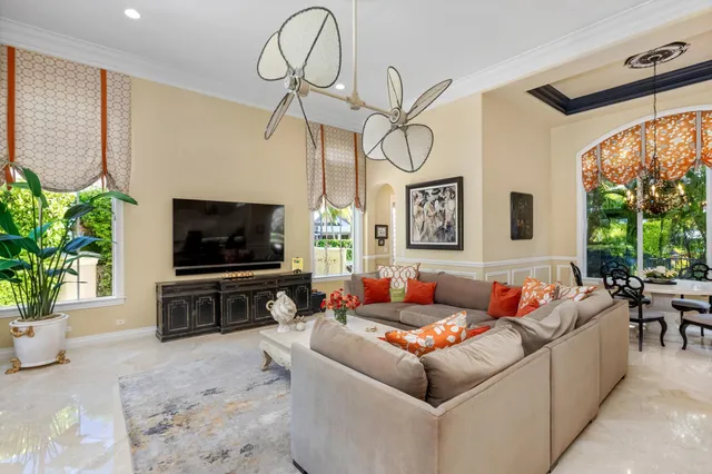 a living room with furniture a rug and a chandelier
