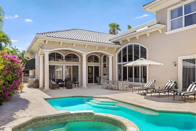 a front view of a house with swimming pool and porch