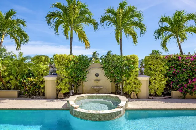 a spacious bedroom with a bed and a chandelier