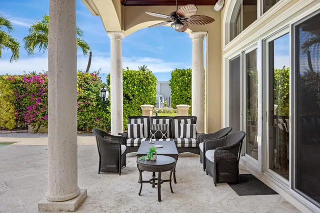 a vase of flowers sitting on a table with a mirror