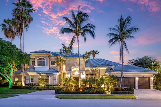 a front view of multiple houses with yard