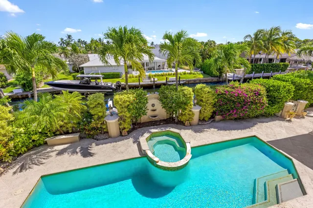 a bathroom with a granite countertop sink a toilet and a shower