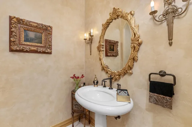 a bathroom with a granite countertop sink a toilet and shower