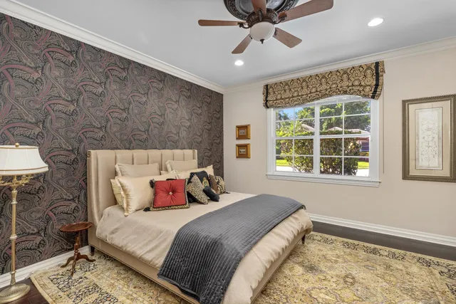 a living room with furniture a potted plant and a large window