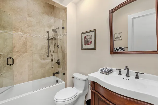 a front view of a house with a garden and trees