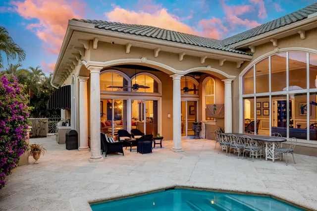 a view of a house with pool and sitting area