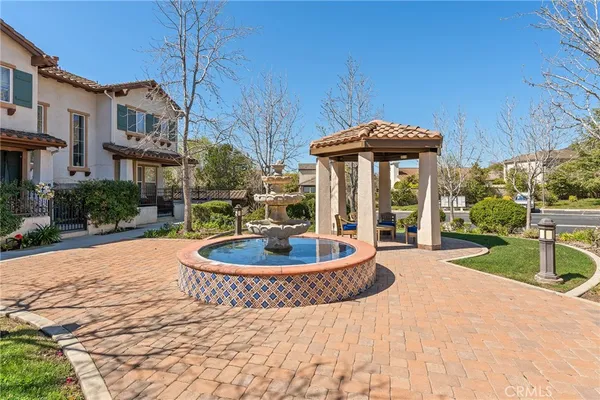 a front view of a house with garden and patio
