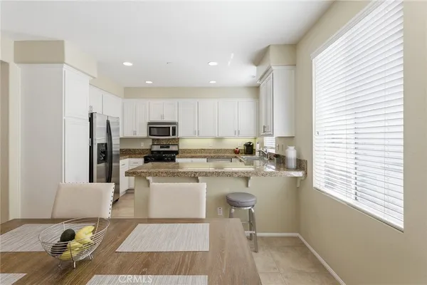a kitchen with a refrigerator and a stove top oven