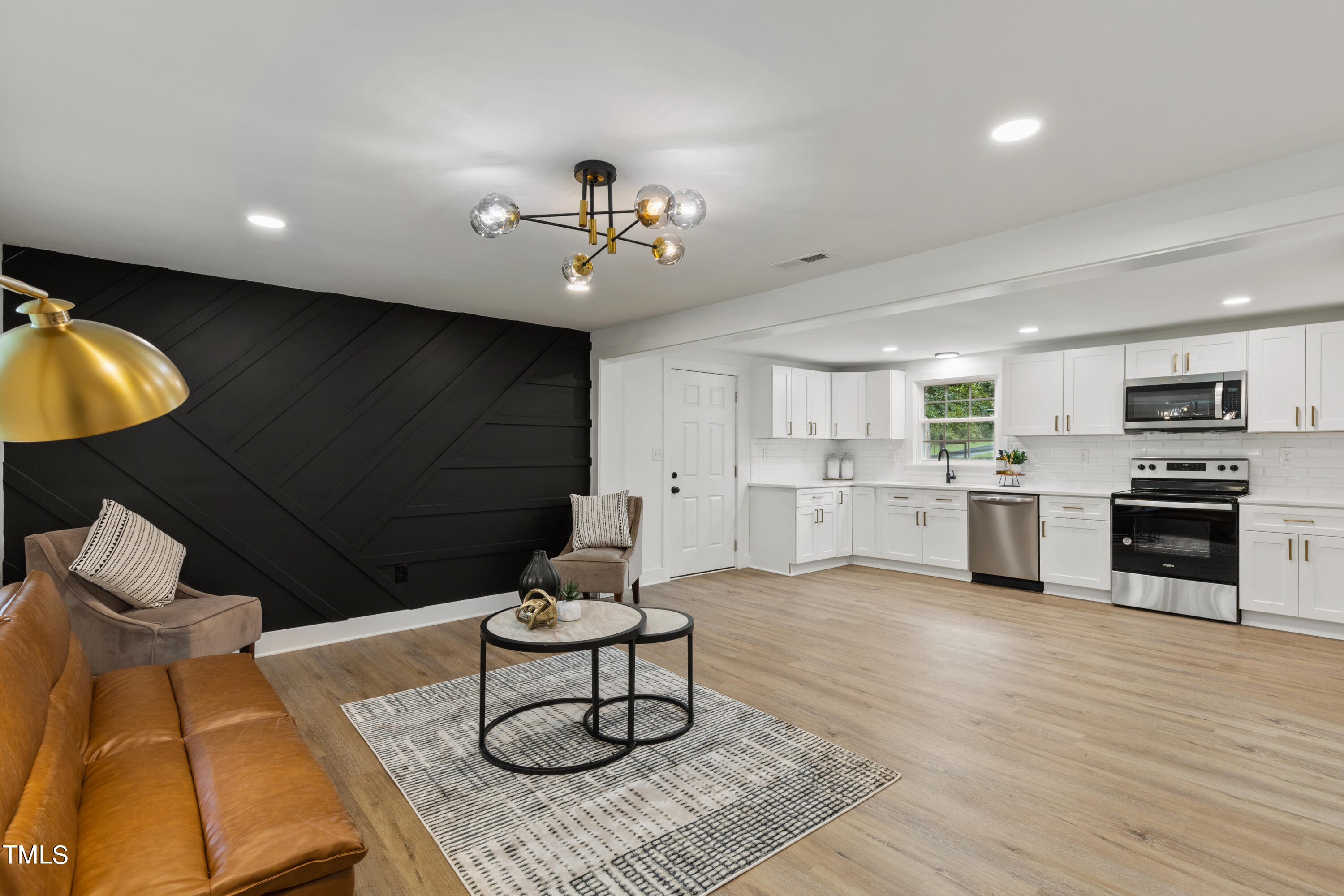 a living room with furniture and kitchen view