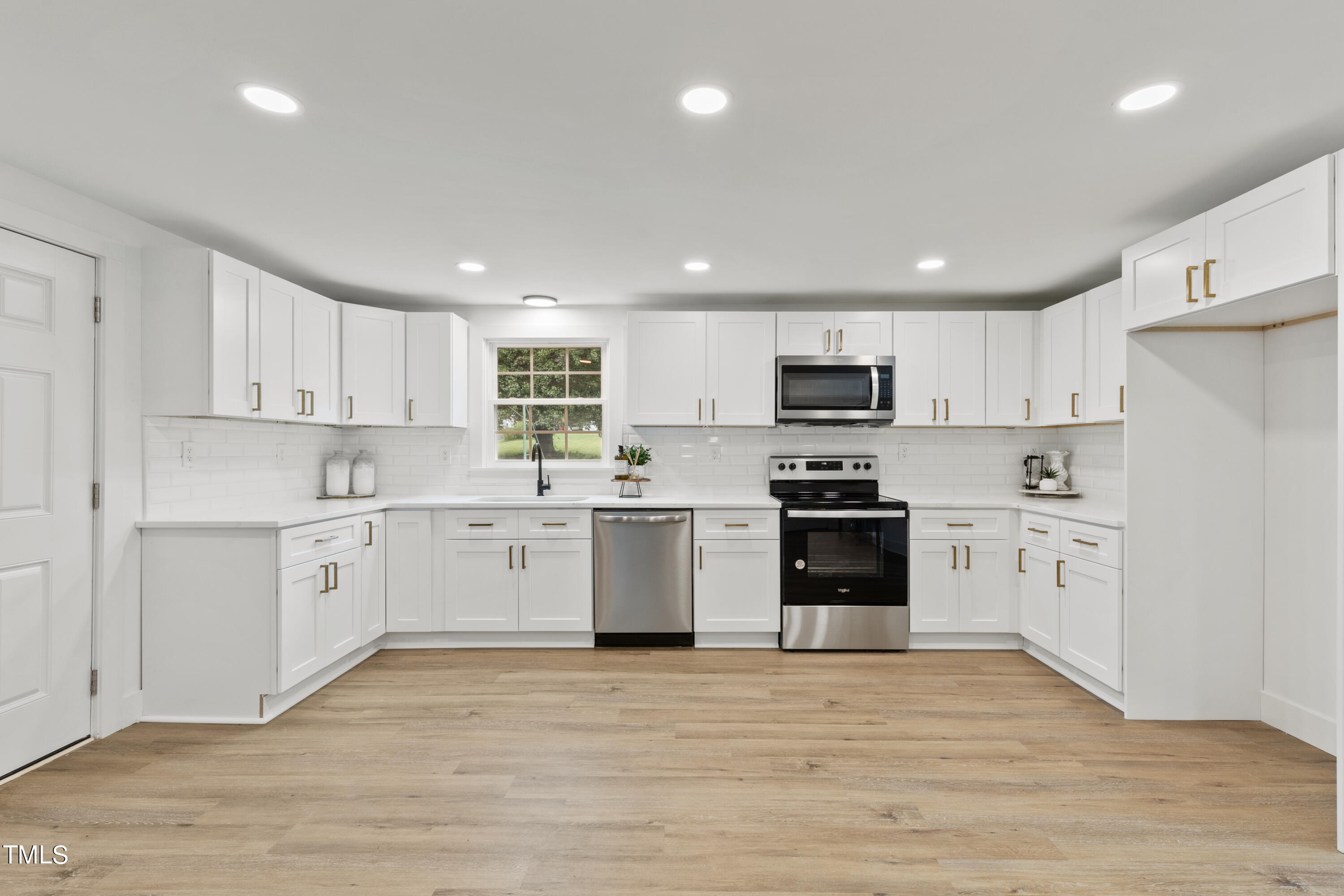 4721 Kimbro Road Hillsborough, NC 27278 - Photo 5 of 11 a kitchen with granite countertop white cabinets and stainless steel appliances