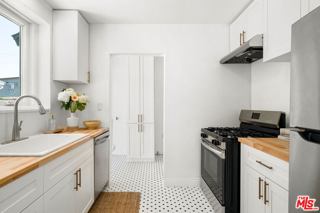 3340 Cardiff Avenue Los Angeles, CA 90034 - Photo 16 of 49 a kitchen with a sink cabinets and appliances