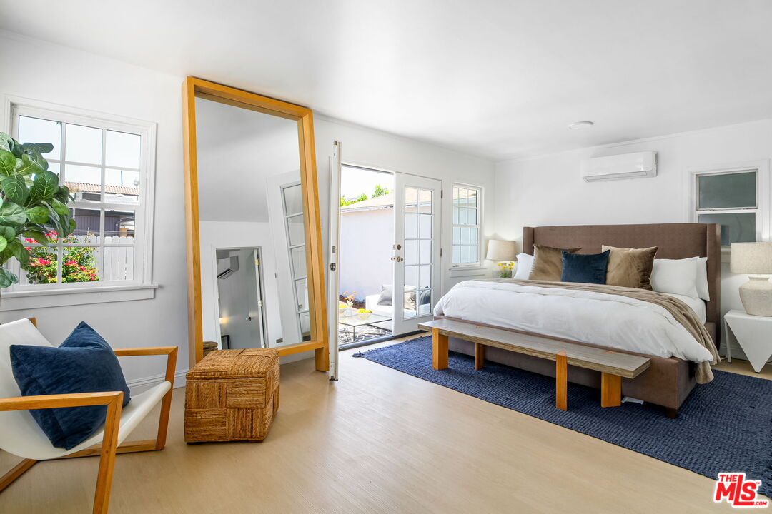 3340 Cardiff Avenue Los Angeles, CA 90034 - Photo 28 of 49 a bedroom with a bed and a couch next to a window