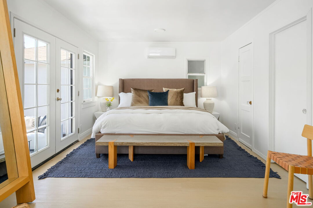 3340 Cardiff Avenue Los Angeles, CA 90034 - Photo 29 of 49 a bedroom with a bed and wooden floor