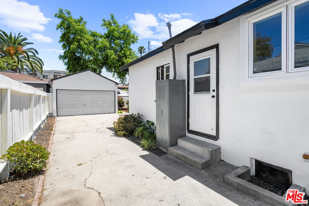 3340 Cardiff Avenue Los Angeles, CA 90034 - Photo 37 of 49 a white house with a yard and parking space