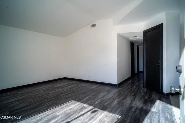 a view of a room with wooden floor and bench
