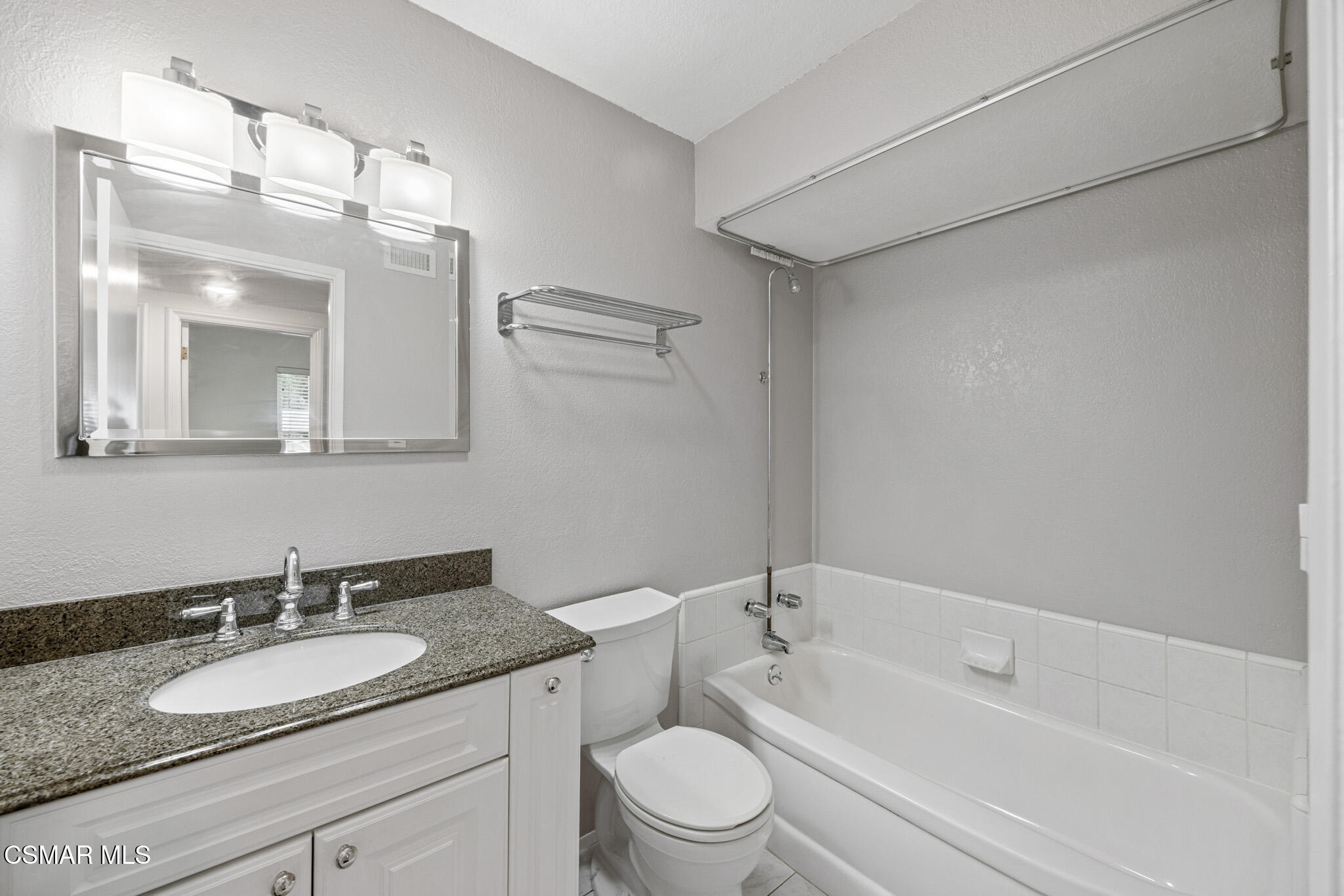 1521 Church Street Simi Valley, CA 93065 - Photo 13 of 16 a bathroom with a granite countertop sink a toilet a mirror and shower