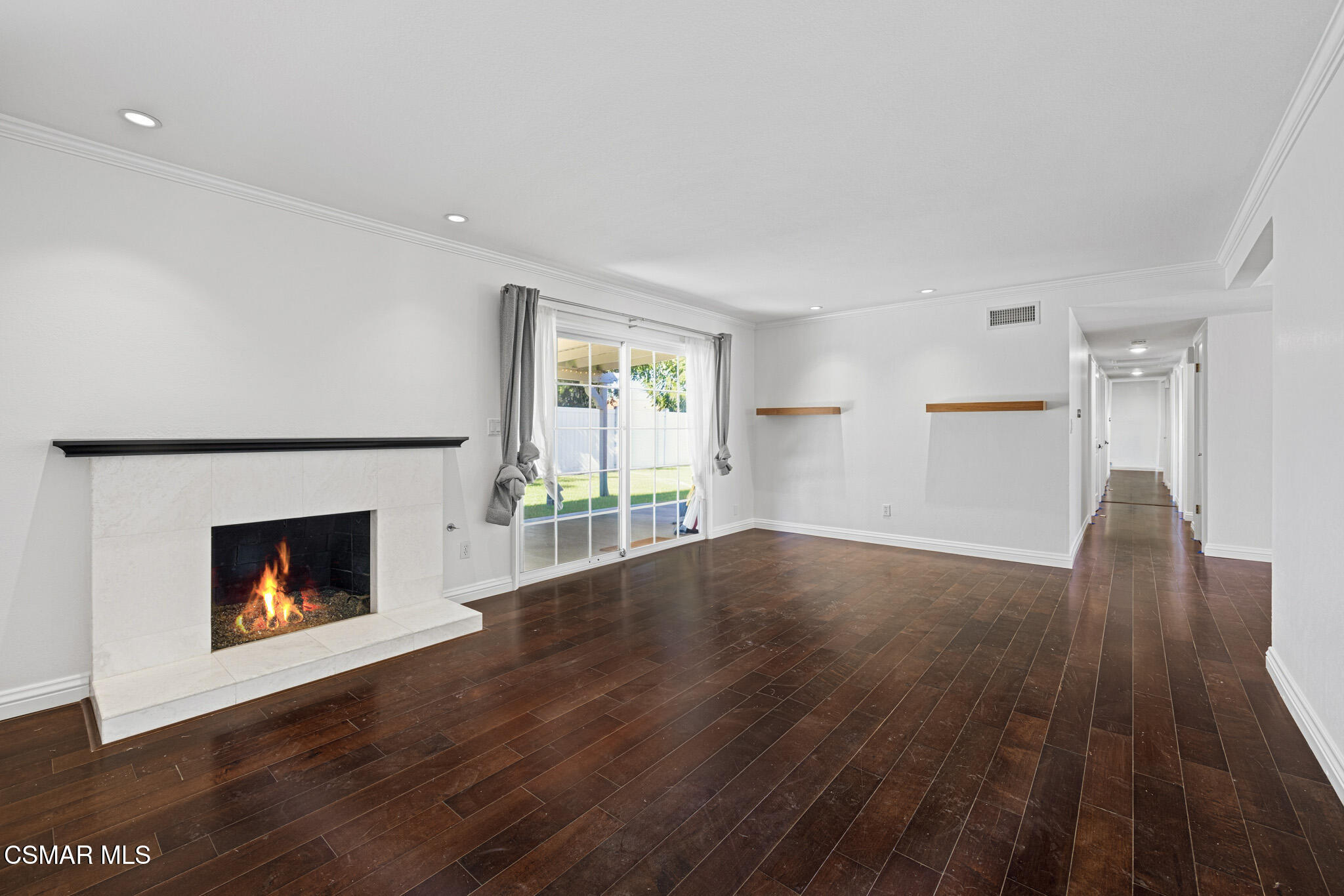 1521 Church Street Simi Valley, CA 93065 - Photo 5 of 16 an empty room with wooden floor fireplace and windows