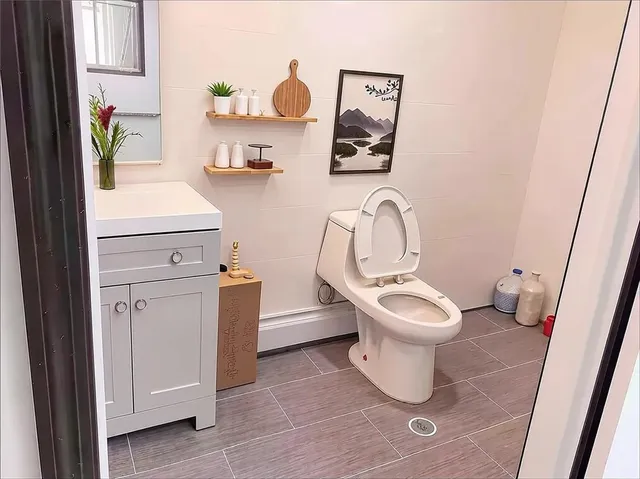 a bathroom with a toilet sink and mirror