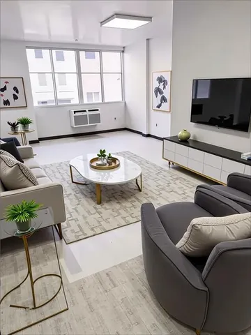 a living room with furniture and a flat screen tv