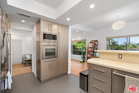 a kitchen with sink cabinets and stainless steel appliances