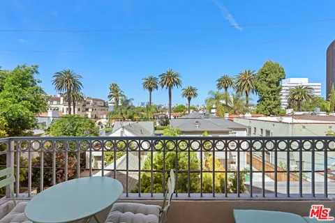 a view of a chairs and table in the balcony