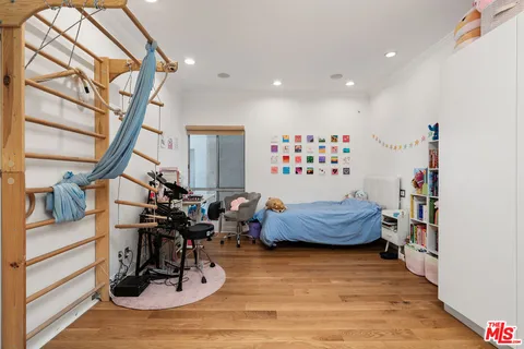 a bedroom with furniture and a wooden floor