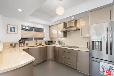 a kitchen with stainless steel appliances a sink stove and refrigerator