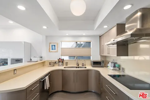 a kitchen with a sink stove and cabinets