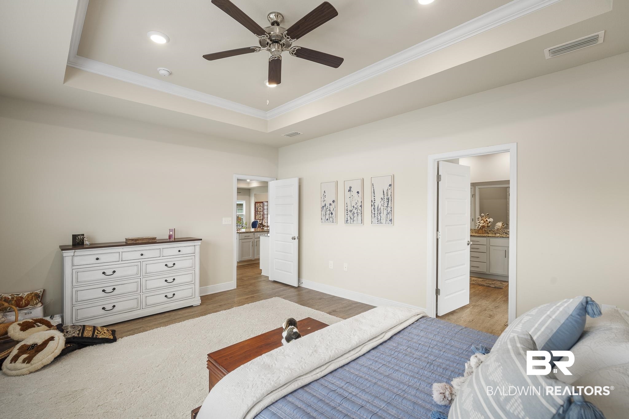24765 Spectacular Bid Loop Daphne, AL 36526 - Photo 26 of 45 Bedroom featuring ceiling fan, connected bathroom, ornamental molding, light hardwood / wood-style floors, and a raised ceiling