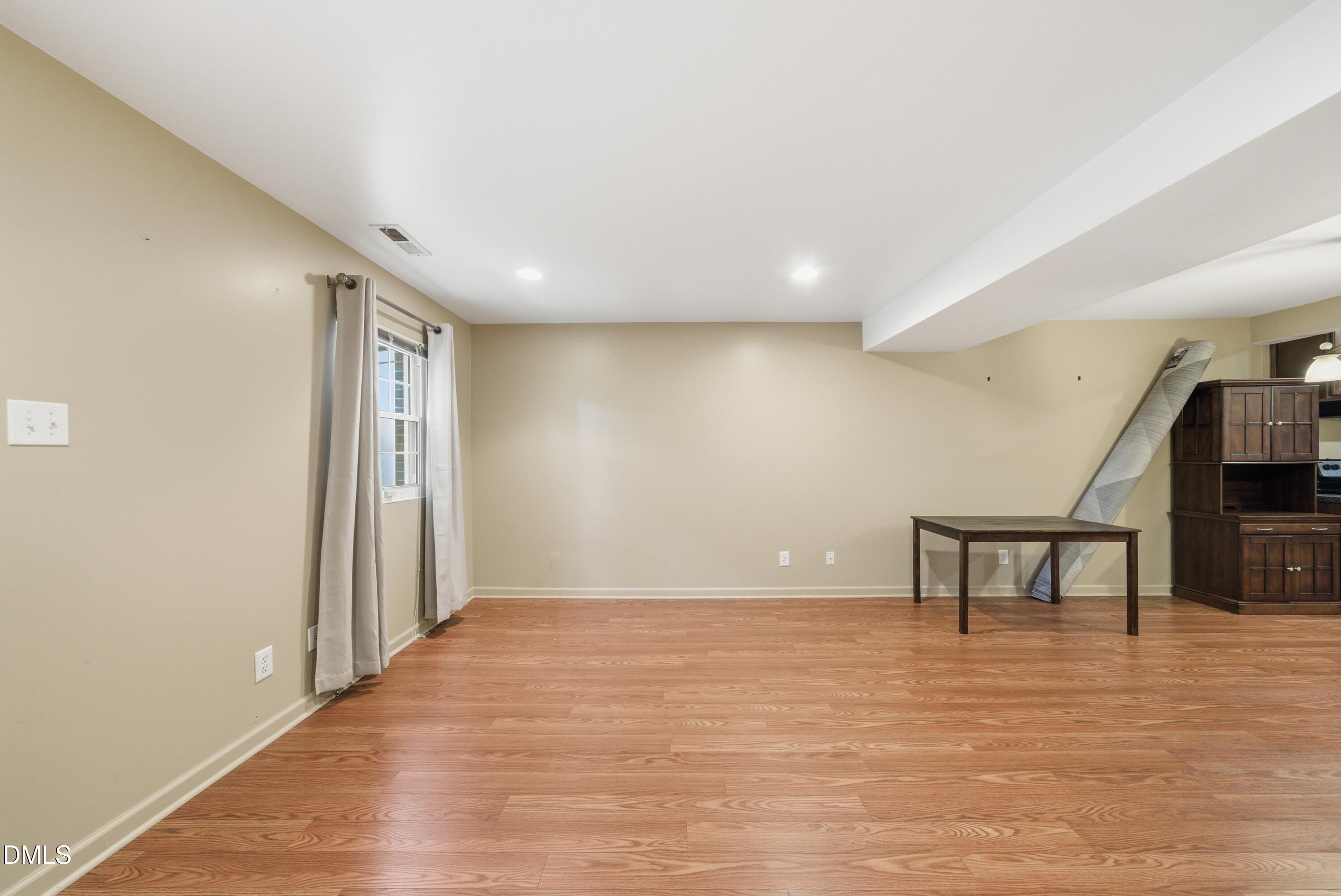 6355 New Market Way Raleigh, NC 27615 - Photo 18 of 30 a view of room with furniture and wooden floor