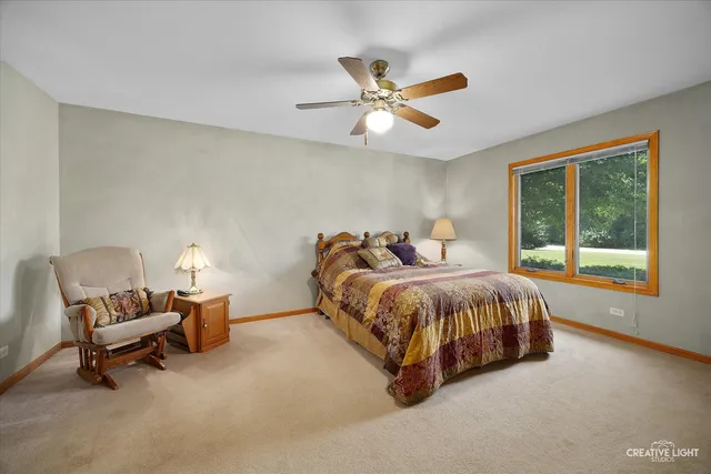 a spacious bedroom with a bed and a window