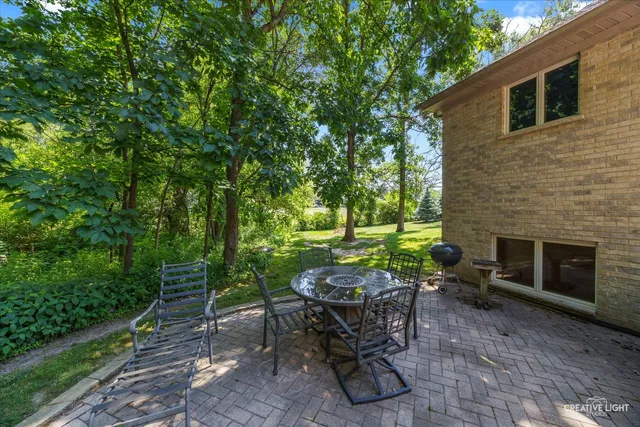 a view of a chairs and table in backyard of the house