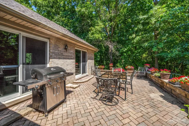 a view of a patio with table and chairs and potted plants