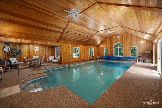 a view of a swimming pool with outdoor seating