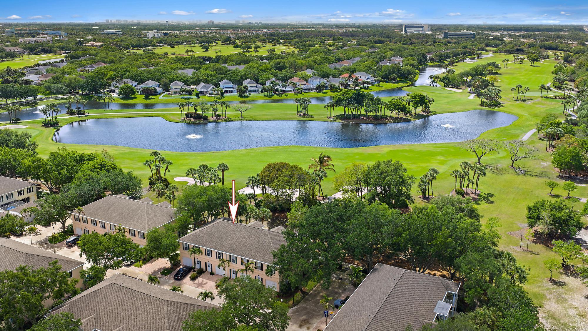 an aerial view of residential houses with outdoor space and river