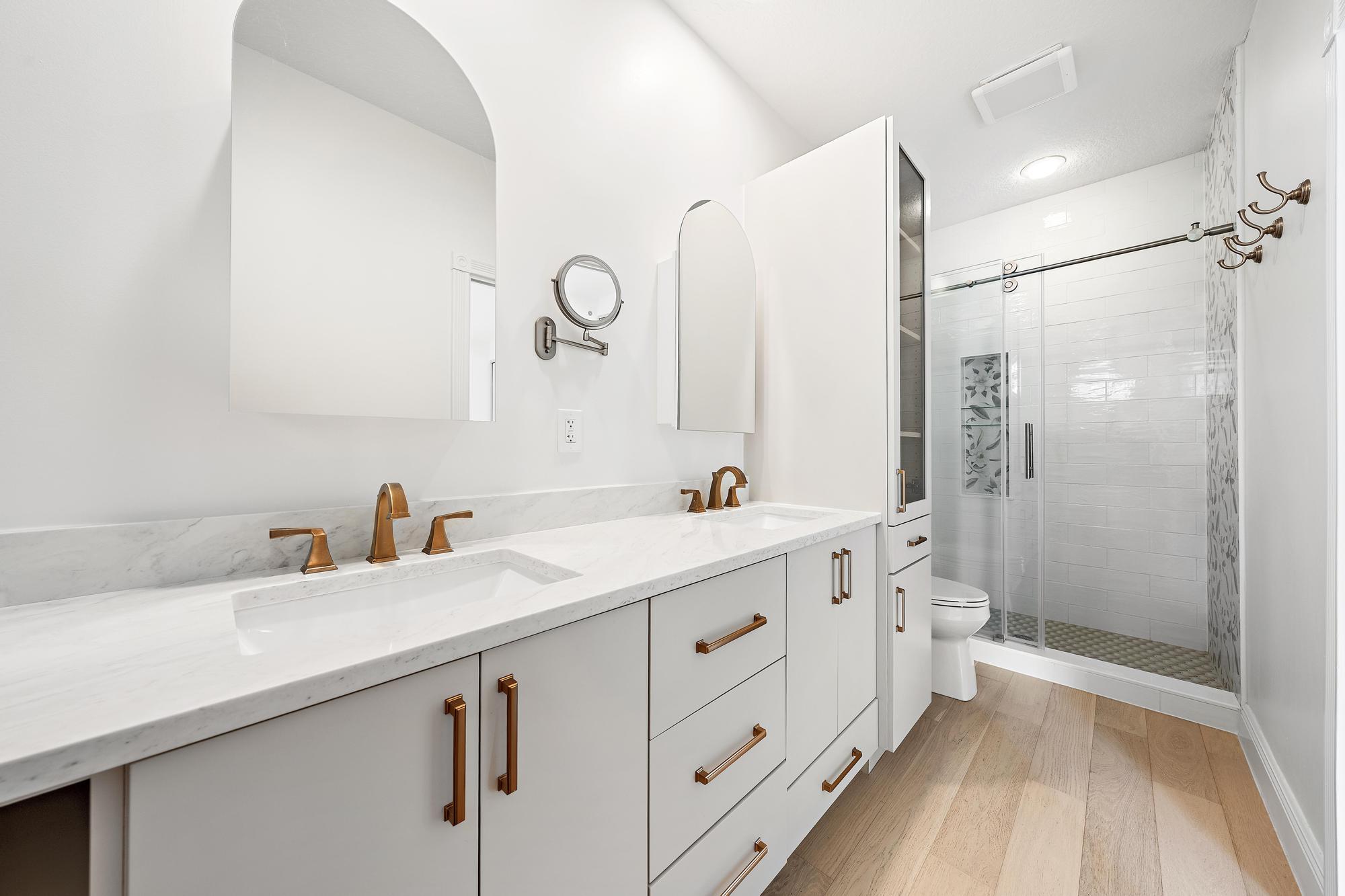 136 Ashley Court Jupiter, FL 33458 - Photo 12 of 26 a bathroom with a double vanity sink mirror and shower