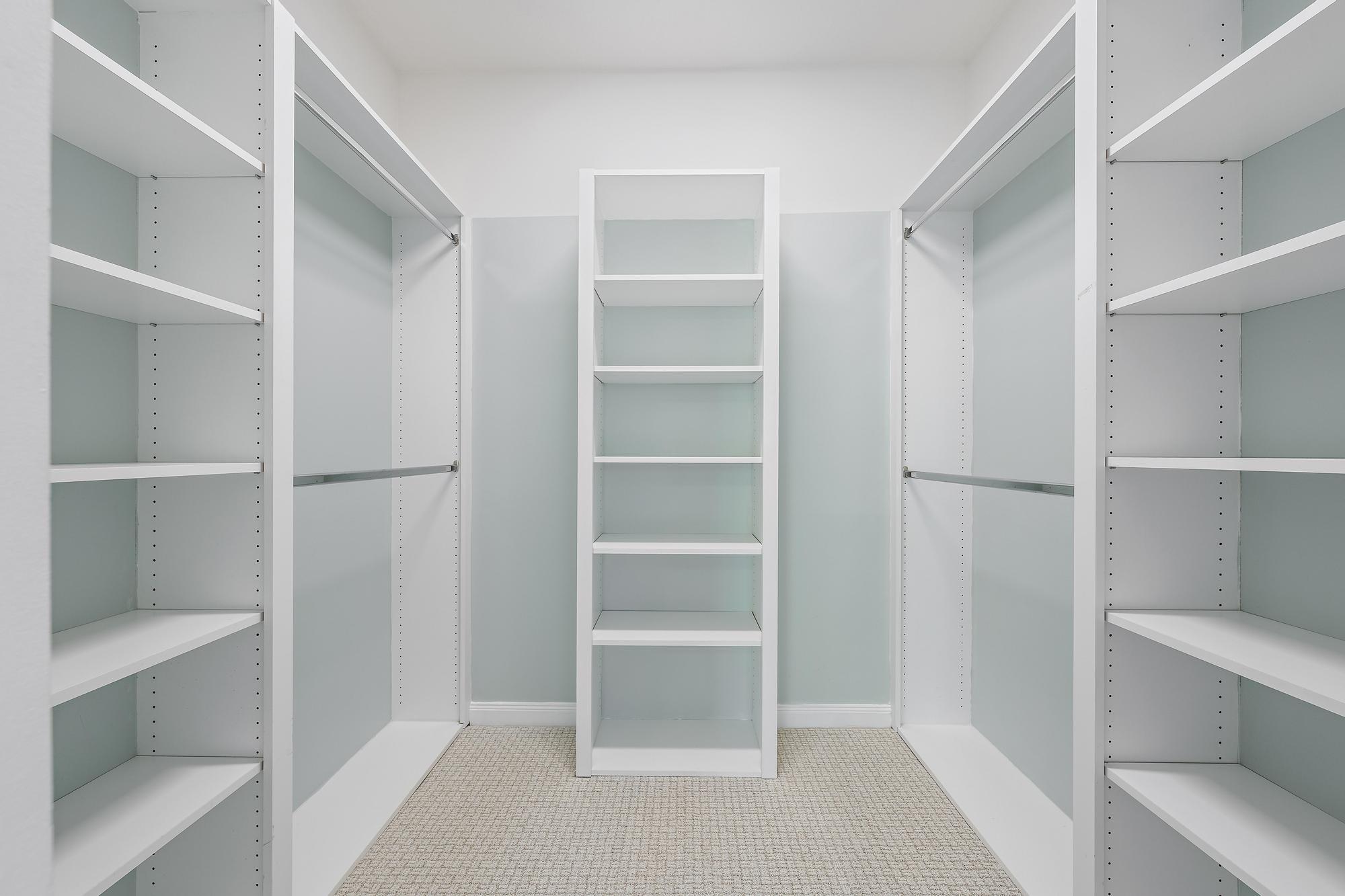 136 Ashley Court Jupiter, FL 33458 - Photo 14 of 26 a view of walk in closet with empty racks