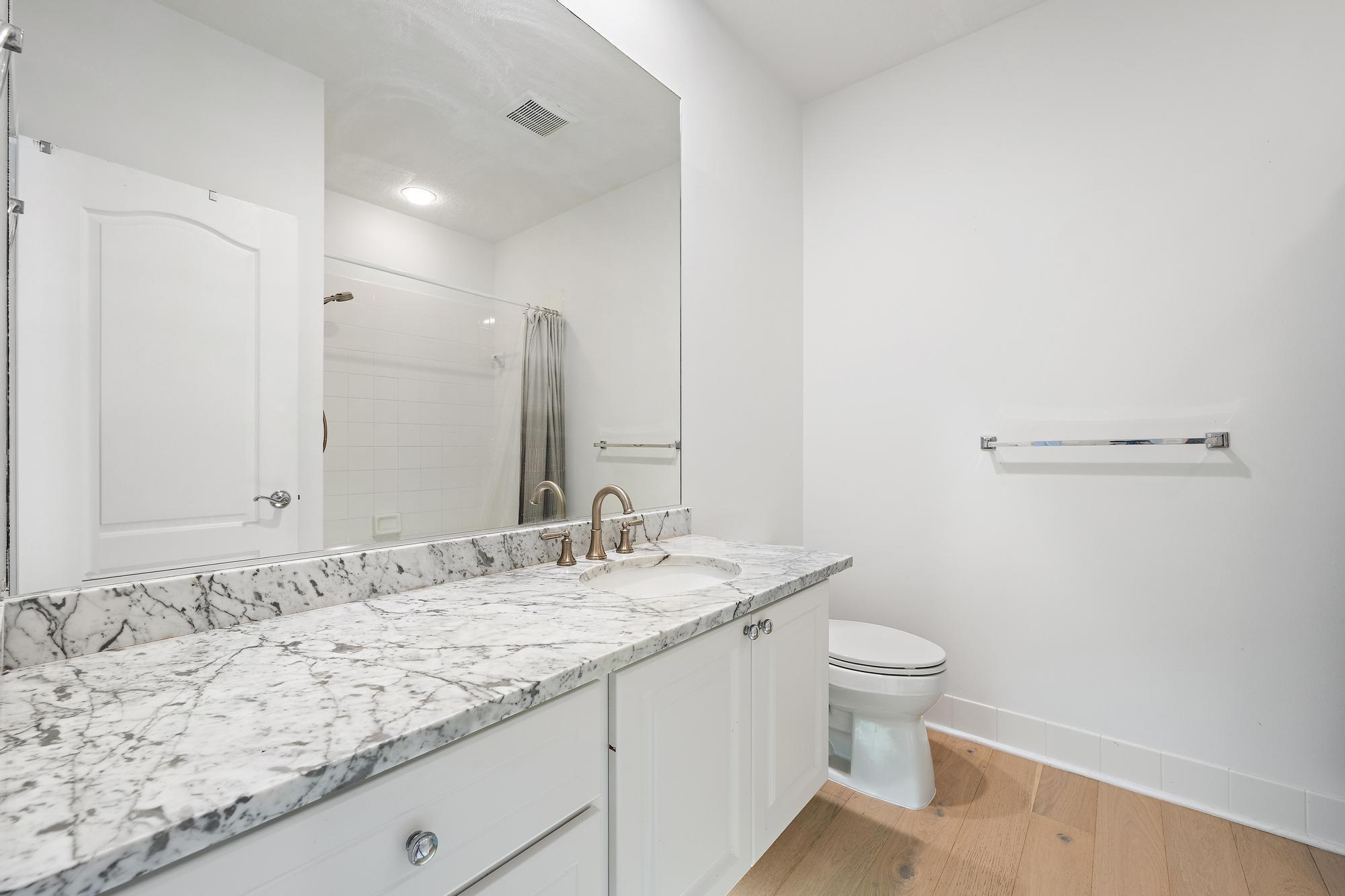 136 Ashley Court Jupiter, FL 33458 - Photo 17 of 26 a bathroom with a granite countertop sink and a mirror