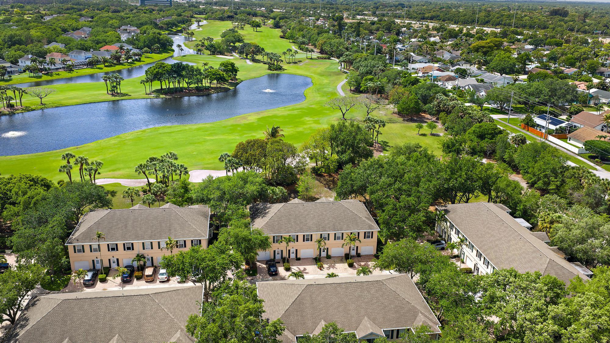 136 Ashley Court Jupiter, FL 33458 - Photo 24 of 26 an aerial view of a house with a garden and lake view