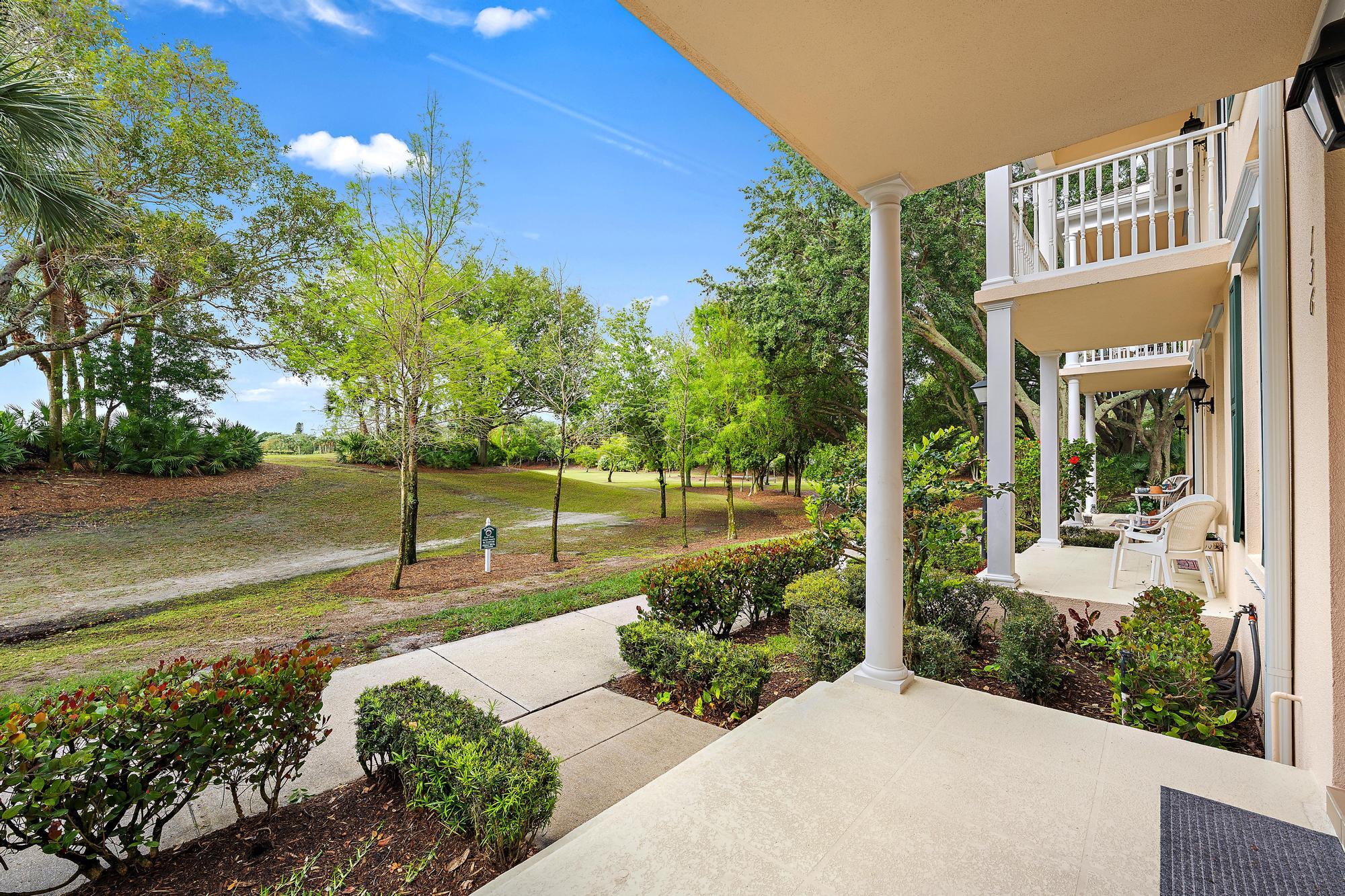 136 Ashley Court Jupiter, FL 33458 - Photo 3 of 26 a front view of a house with garden